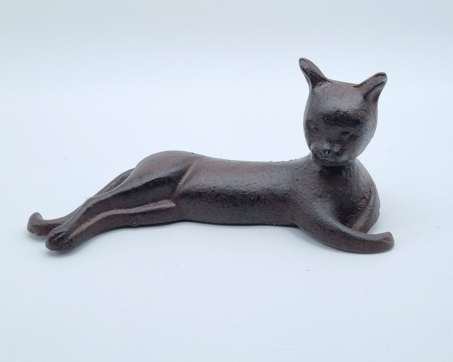 Cast iron statue of a reclining cat - artistic